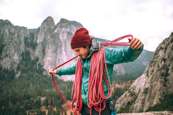 Rock Climbing Guy Coiling a rope in Yosemite National Park