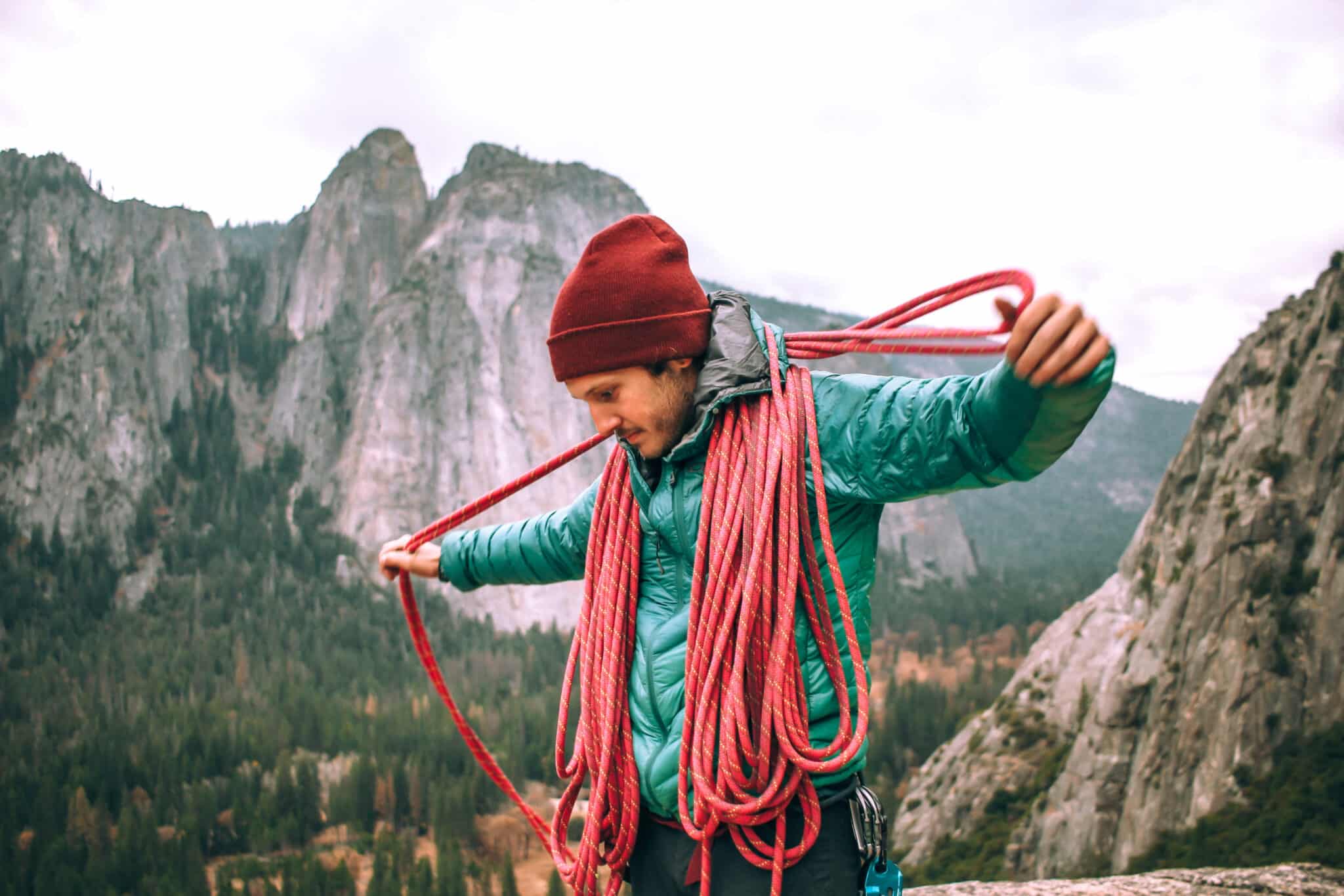 Man coiling rope in Yosemite National Park rock climbing